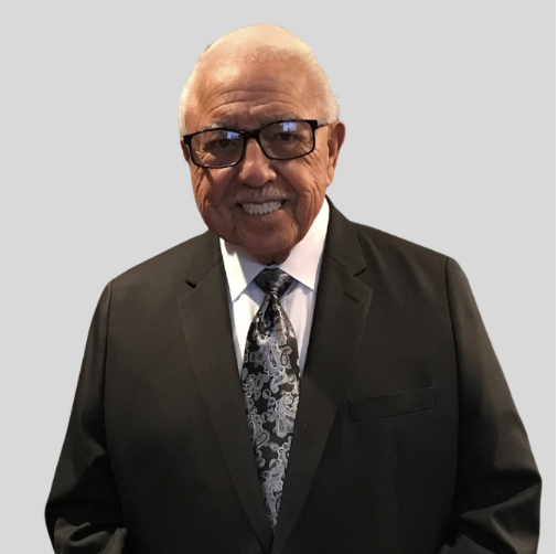 Portrait of a smiling older man in a black suit and tie